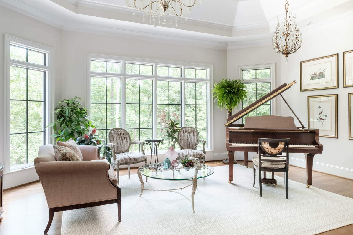 Bright living room with grand piano in a custom-built home by Wolfe Homes in Greensboro, NC