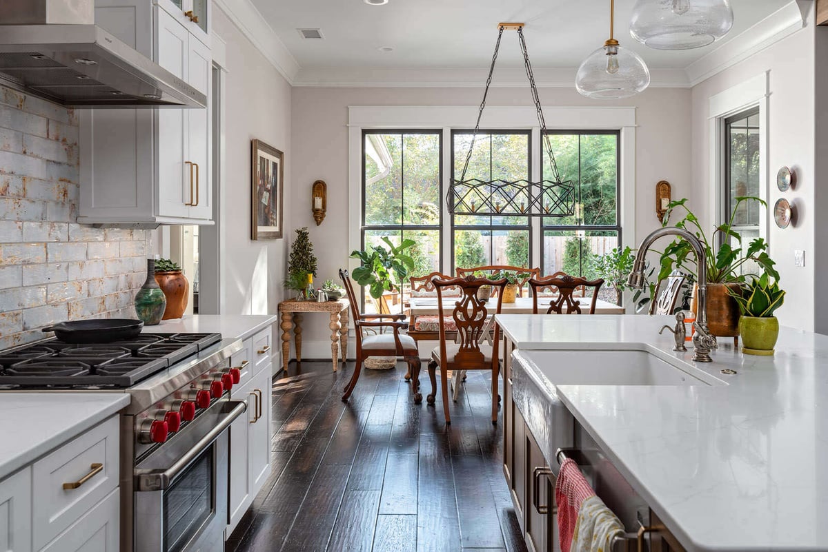 Open kitchen and dinette area in custom Greensboro remodel by Wolfe Homes, with a view to the backyard