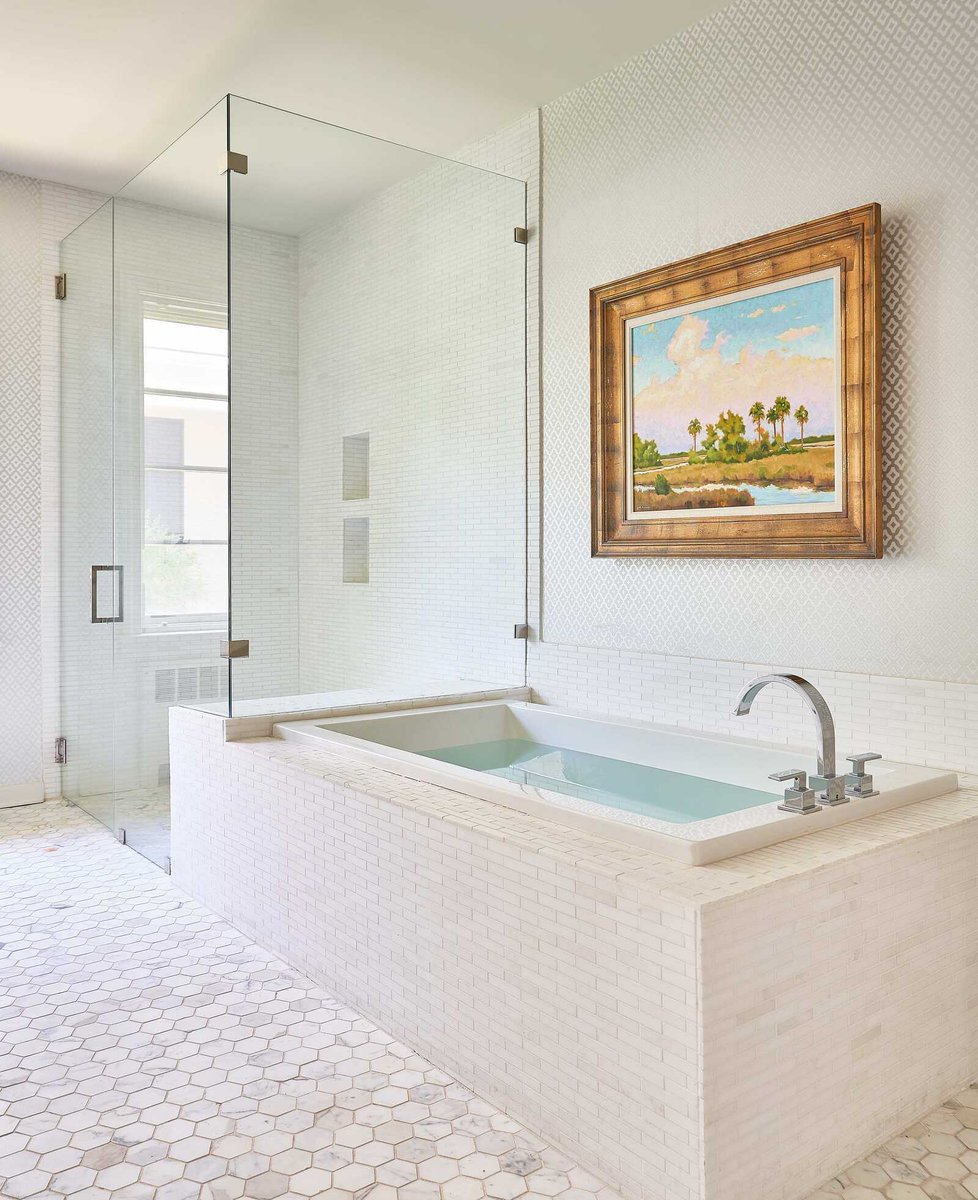 Luxurious bathroom with large soaking tub and framed wall art