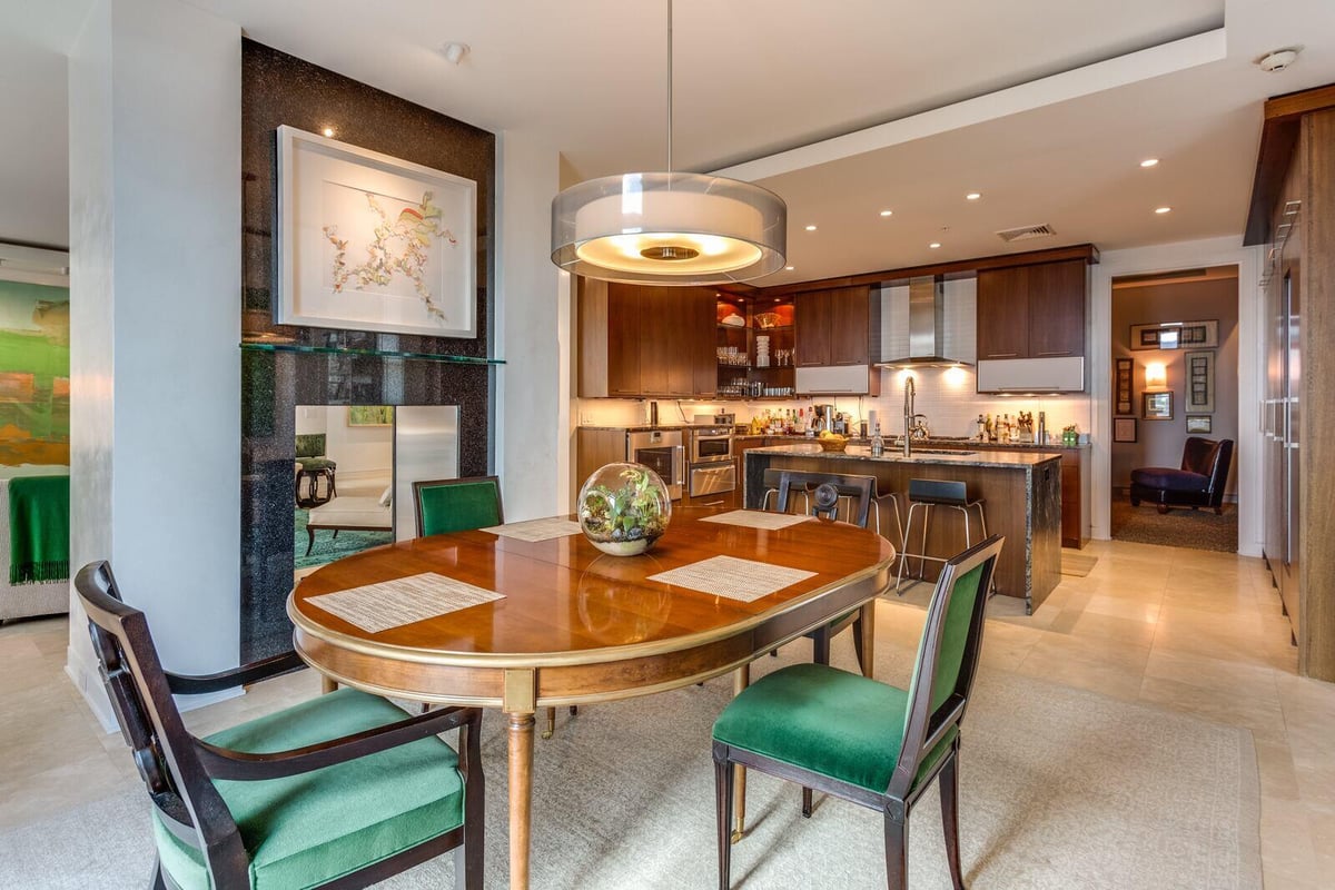 Elegant dining area with wooden dining table and green chairs in a Greensboro custom home by Wolfe Homes