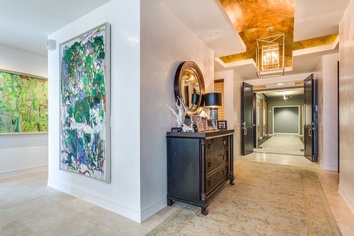 Elegant hallway with artwork and decorative mirror in a custom home by Wolfe Homes, Greensboro, NC