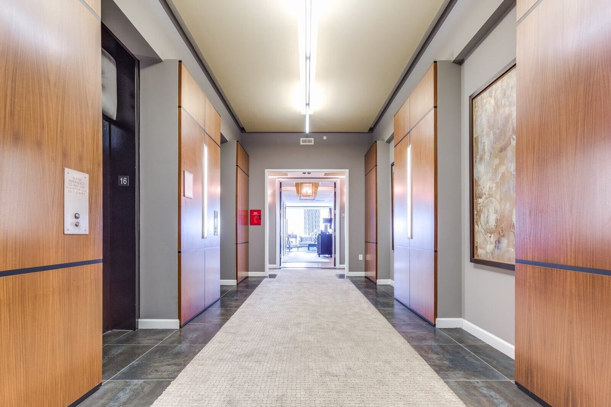 Elegant lobby-style hallway with wooden panel accents in a Greensboro custom home by Wolfe Homes