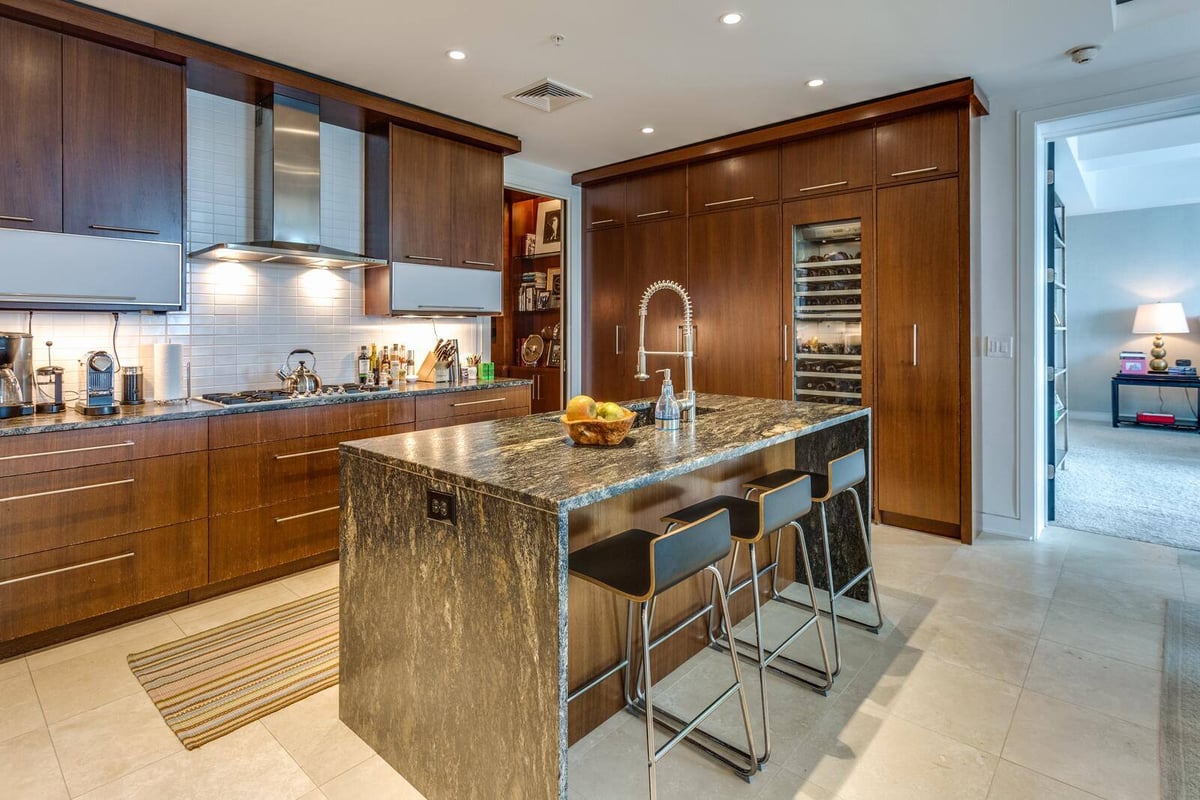 Gourmet kitchen with wooden cabinetry and a central island in a custom home by Wolfe Homes in Greensboro, NC