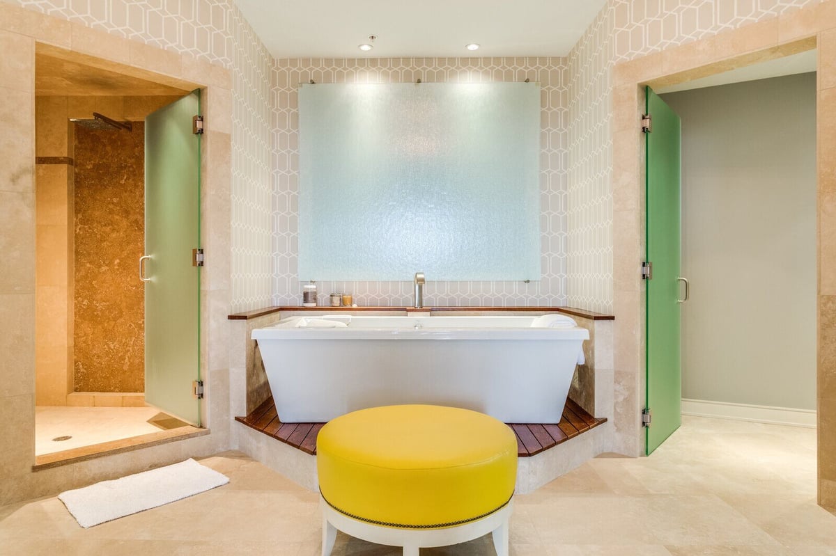 Luxurious bathroom featuring a central soaking tub and contemporary decor in a custom home by Wolfe Homes, Greensboro, NC