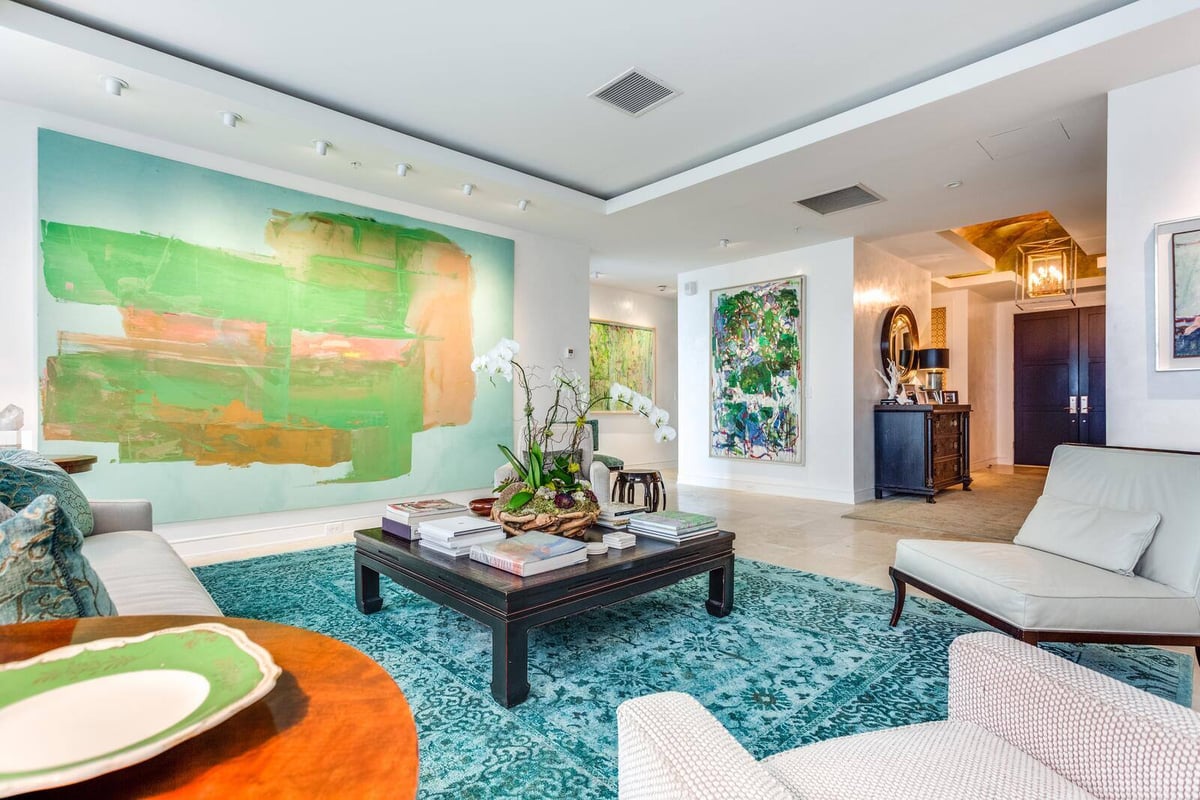 Modern living room with abstract wall art and chic furniture by Wolfe Homes in a Greensboro custom home