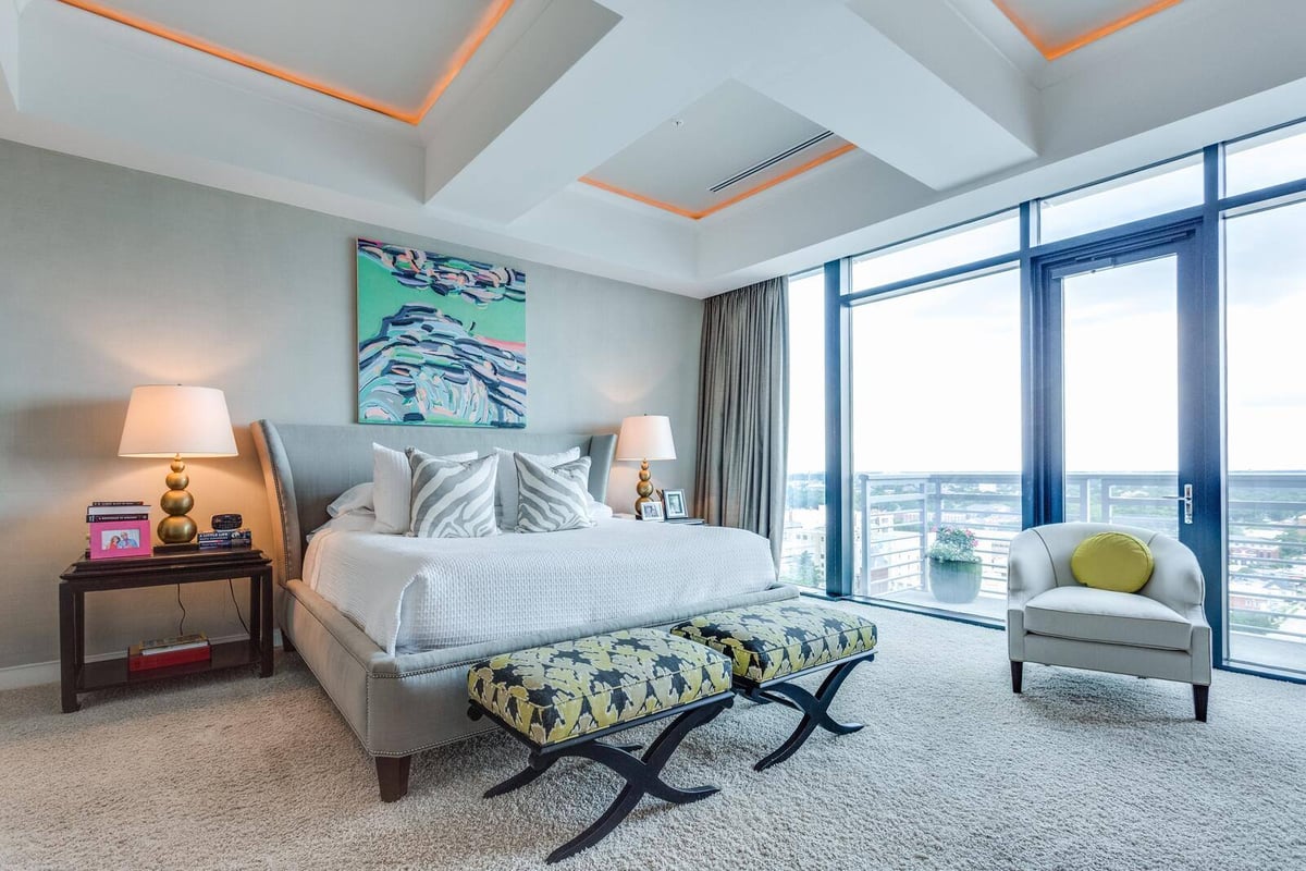 Spacious modern bedroom with large windows and elegant decor in a custom home by Wolfe Homes in Greensboro, NC
