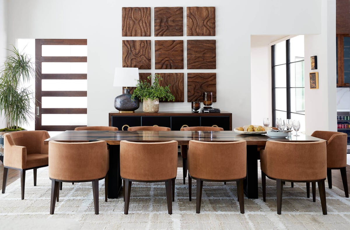 Elegant dining room with leather chairs and a large wood-accented wall decor, designed by Allen & James in Gaston County