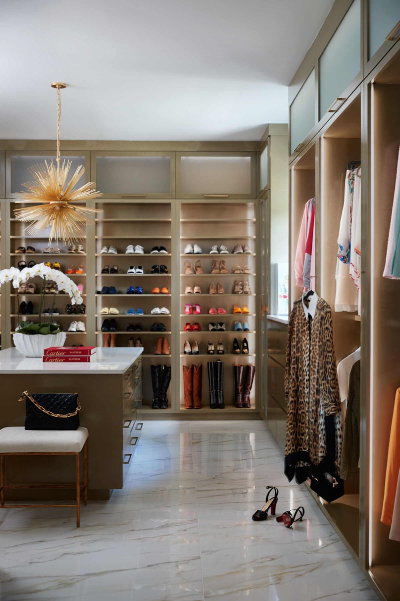 Luxurious walk-in closet with organized shelves and shoe display, designed by Allen & James in Gaston County