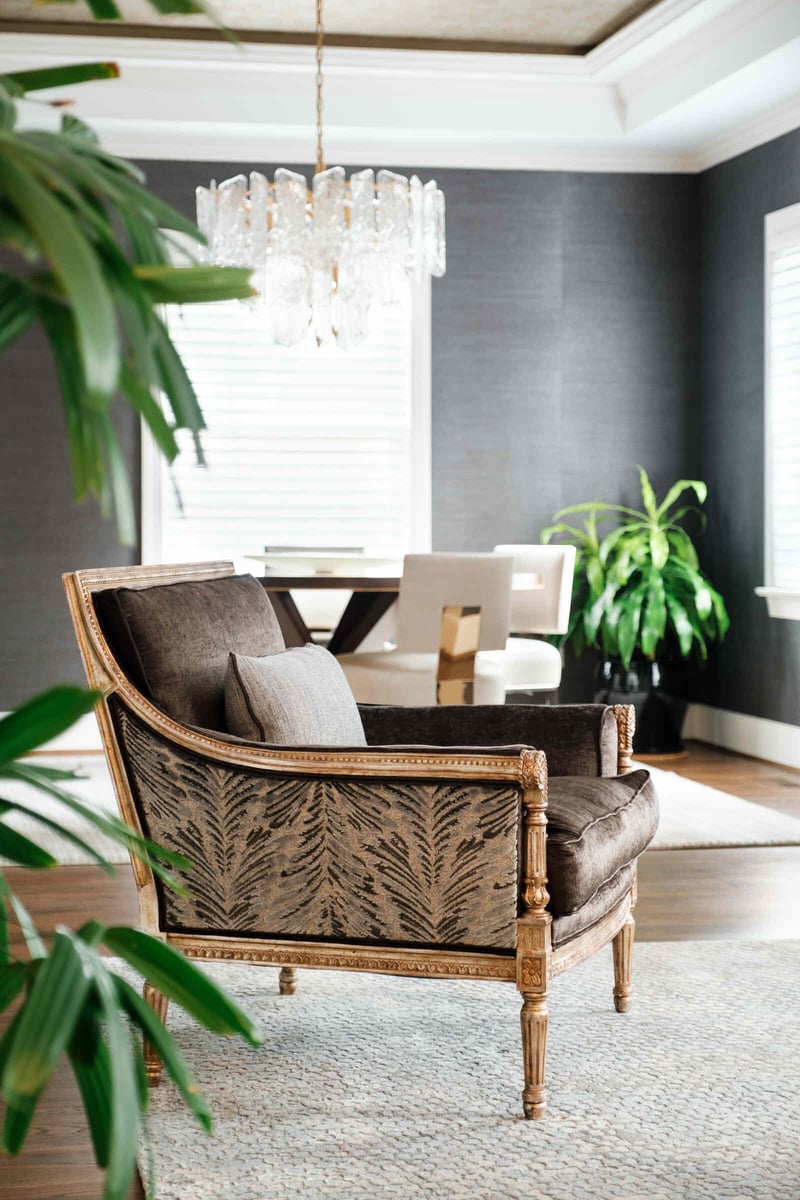 Cozy reading corner with a classic armchair in a remodeled living room by Wolfe Homes, Greensboro, NC