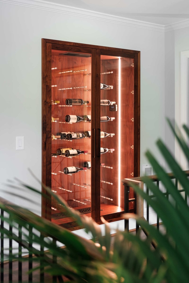 Custom wine cabinet with interior lighting in a Greensboro home remodel by Wolfe Homes