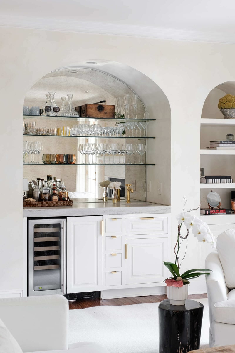 Custom-designed bar nook with glass shelving in a Greensboro remodel by Wolfe Homes