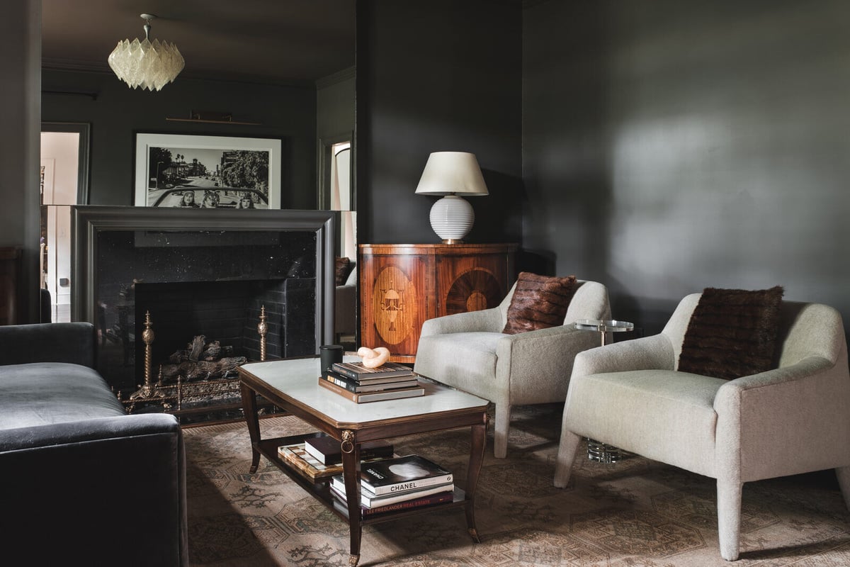 Moody living room with dark walls and vintage decor in Wolfe Homes custom remodel in Greensboro, NC