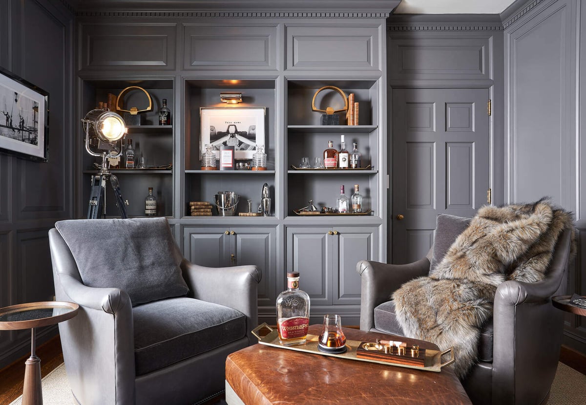 Stylish lounge with bar and plush seating in a custom remodel by Wolfe Homes, Greensboro, NC