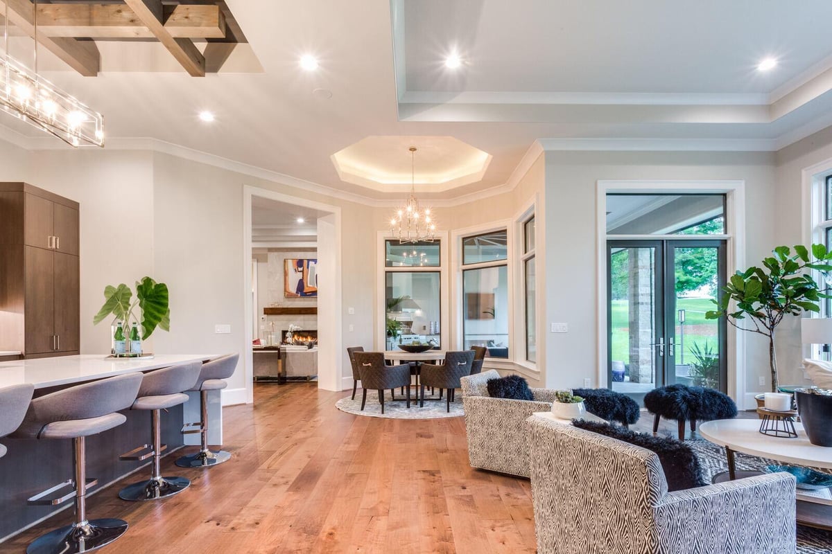 Open-concept kitchen and living area in Greensboro custom home by Wolfe Homes