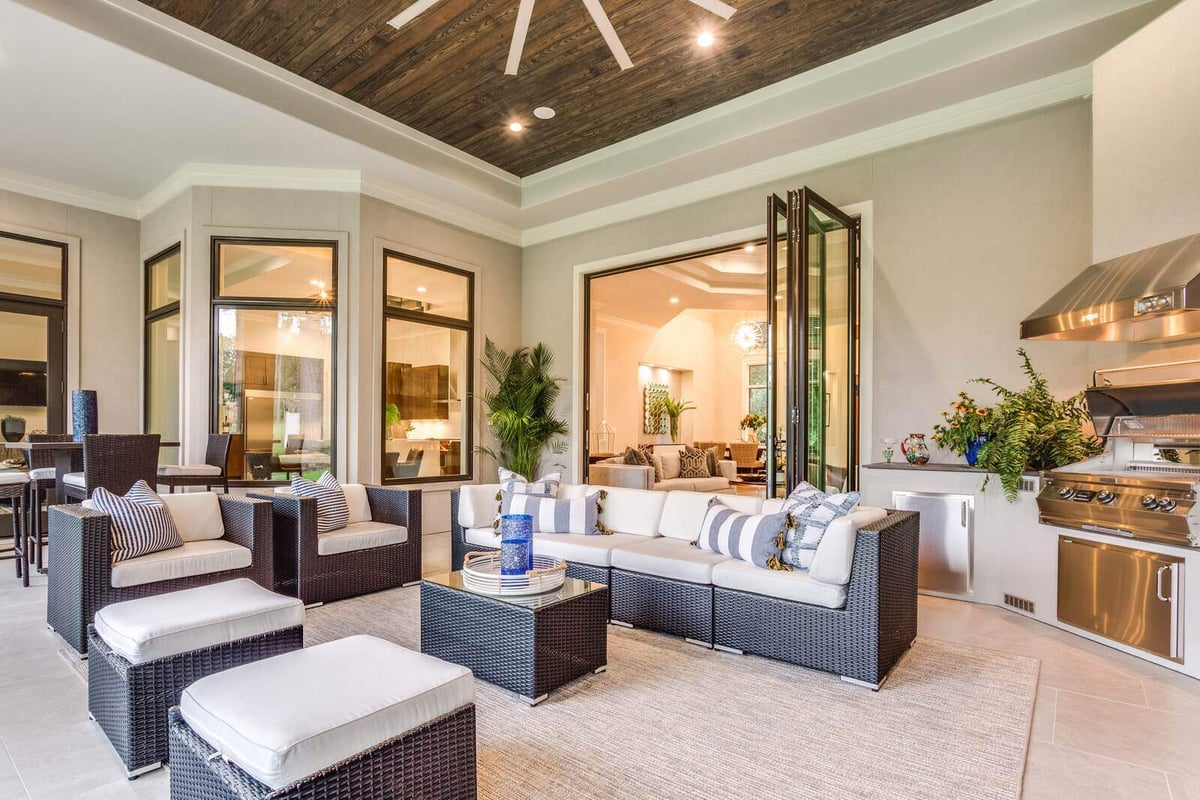 Spacious outdoor patio with seating and built-in grill in Greensboro custom home by Wolfe Homes