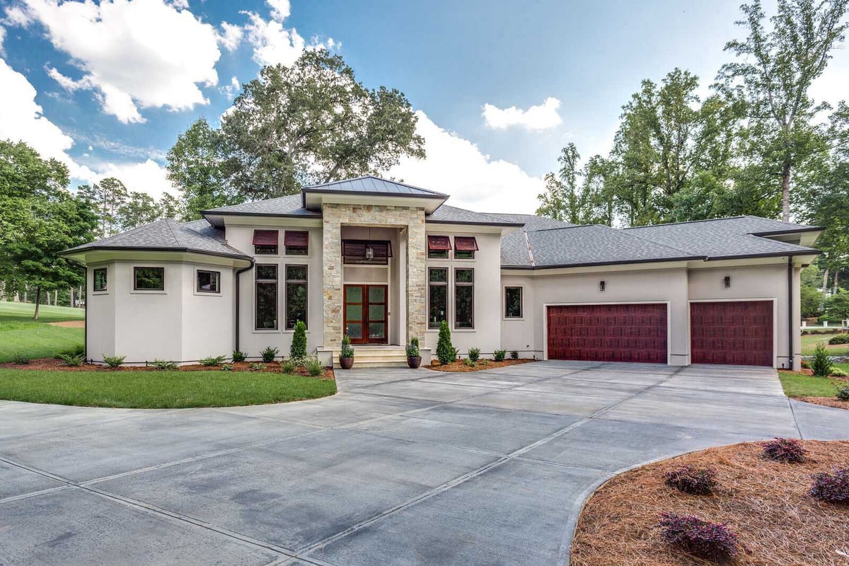 Stunning exterior of Greensboro custom home by Wolfe Homes with spacious driveway